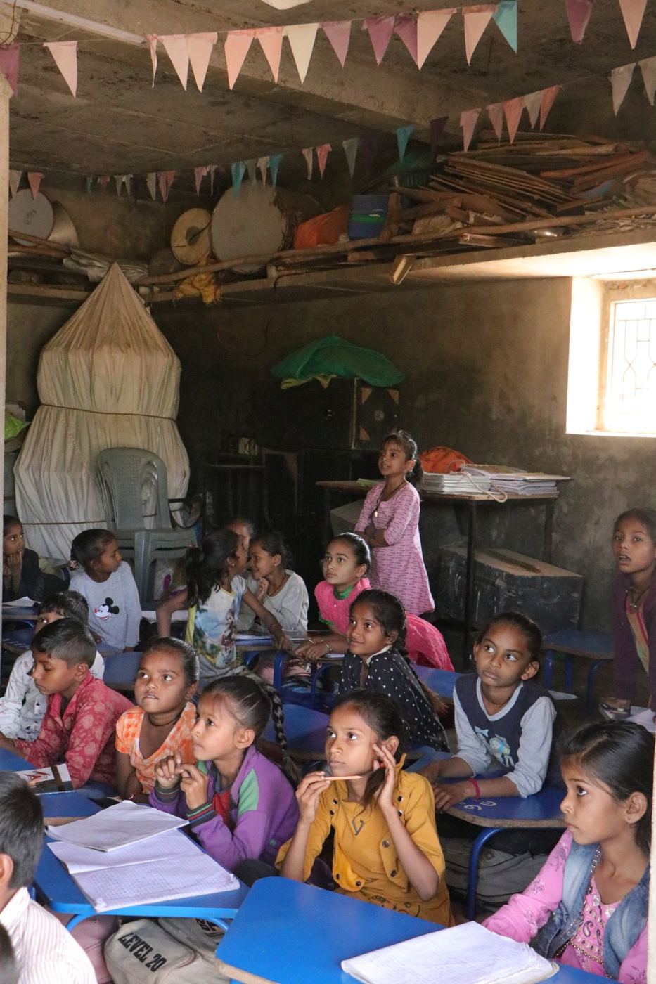 Children studying together in a village classroom