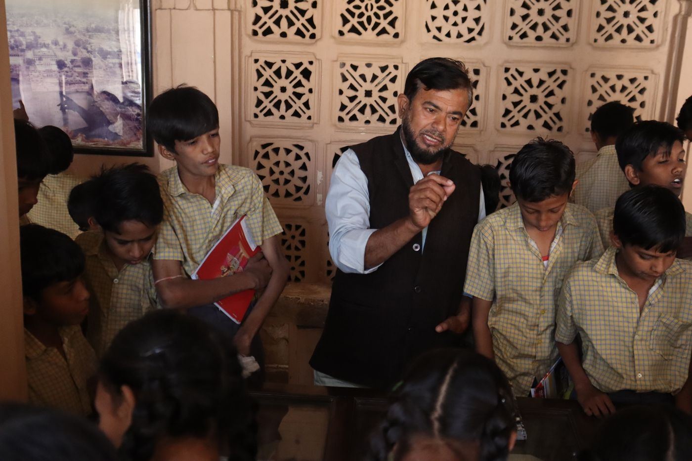 A teacher explaining a lesson to a group of students